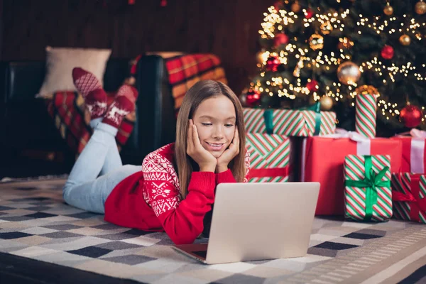图片上可爱快乐的小女孩穿着红色印花毛衣订新年礼物现代装置室内居室 — 图库照片