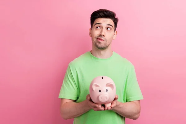 Photo Young Man Thinking Hold Piggy Bank Looks Interested Choosing — Stock Photo, Image