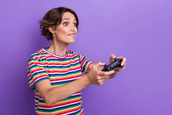 Profile photo of nervous person hold controller play games biting lips tryhard isolated on violet color background.