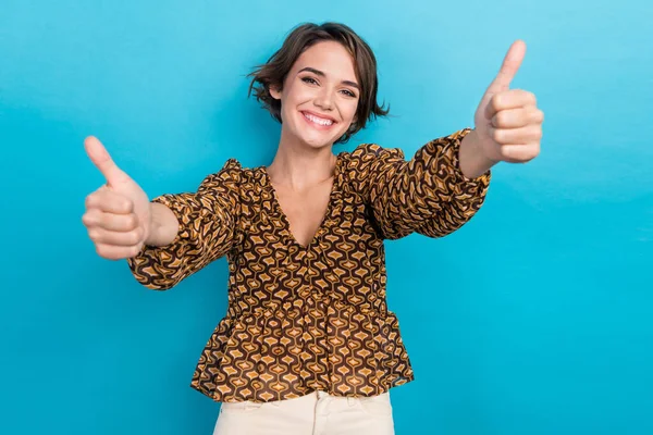 Portrait photo of nice cheerful smile funny woman double thumbs up symbol good job feedback advice isolated on blue color background.