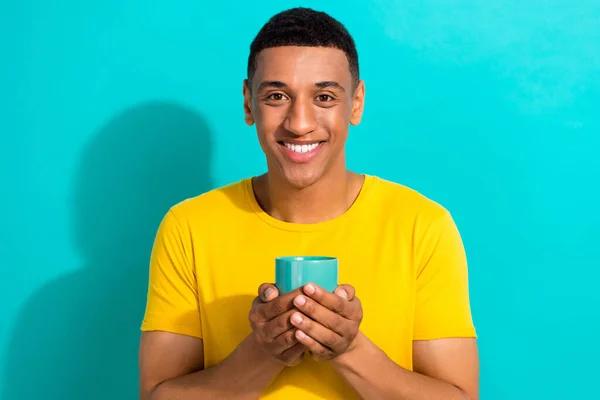 Photo of cute young man hold cup hot tea break time pause relax drinking beverage good morning isolated on aquamarine color background.