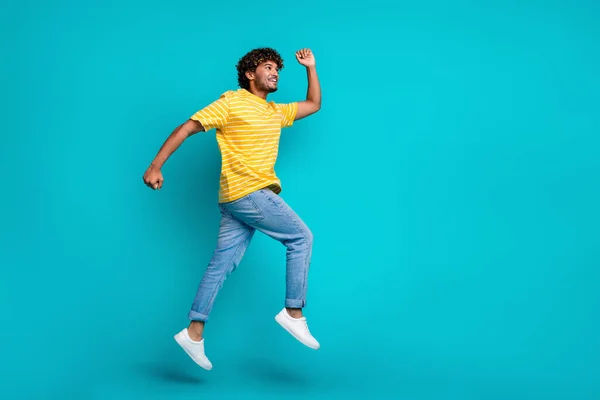 Full body profile portrait of crazy sportive person jumping running empty space isolated on turquoise color background.