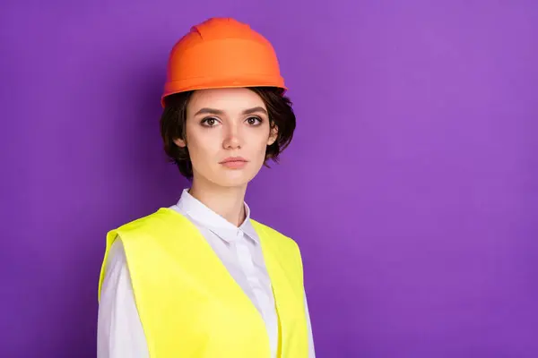 Profile photo of serious nice brunette hair lady wear builder uniform isolated on vivid purple color background.