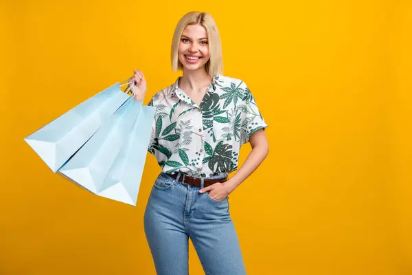 Photo of shiny sweet woman dressed print shirt rising shopping bargains isolated yellow color background.