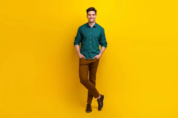 Full length photo of positive attractive man successful boss dressed nice outfit isolated on yellow color background.
