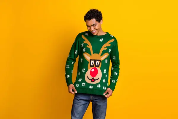 Photo of funky cool guy wear new year ugly print sweater looking clothes isolated yellow color background.