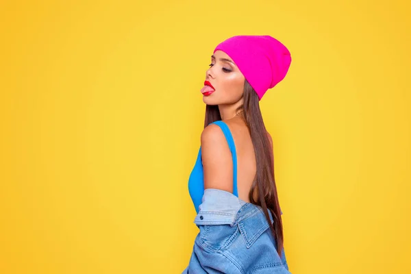Side profile view photo portrait of attractive confident charming gorgeous lady showing tongue looking down isolated bright vivid pastel background.