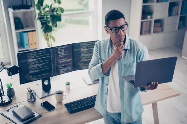 Photo of intelligent creative executive director business it startup company man thinking how solve database bug on pc monitors background.