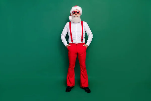 Full length photo of successful man dressed new year red white clothes ready chill relax rest corporate isolated on green color background.