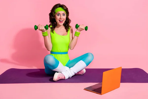 Photo of funny sporty coach lady doing weight power lifting recording video on sport blog netbook isolated pastel color background.