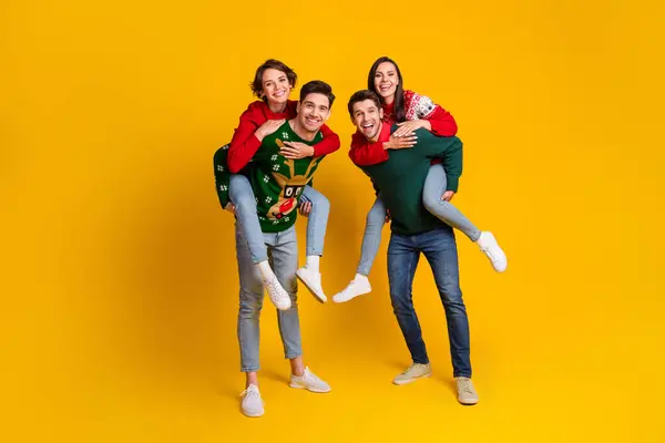 Photo of four best buddies people have fun on christmas event occasion piggyback isolated shine color background.