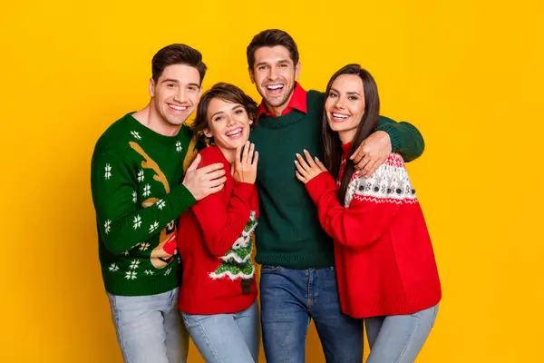 Photo of positive cheerful youth people cuddle together on christmas event meeting isolated bright color background.
