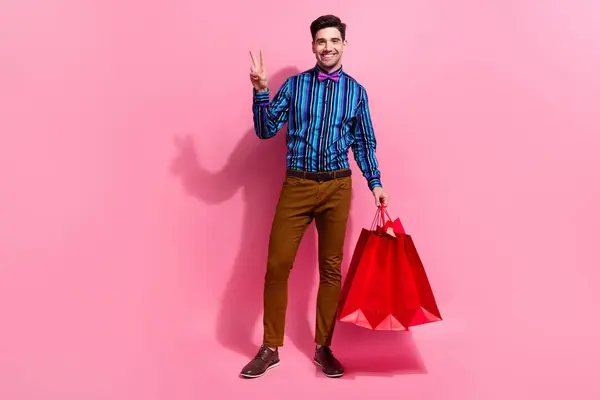 Full Body Photo Friendly Guy Showing Sign Holding Red Packages — Stock Photo, Image