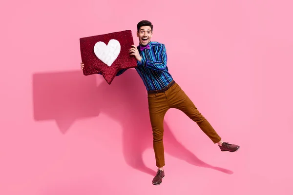 Full body length photo of young guy demonstrate his handmade heart symbol for girlfriend surprising her isolated on pink color background.