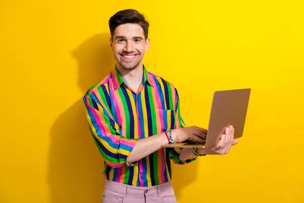 Photo of happy man user hipster in retro shirt new macbook air m3 processor enjoying his productivity isolated on yellow color background.