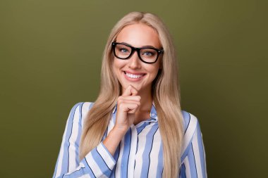 Photo portrait of blonde lovely young lady touch chin thoughtful minded wear trendy striped garment isolated on khaki color background. clipart