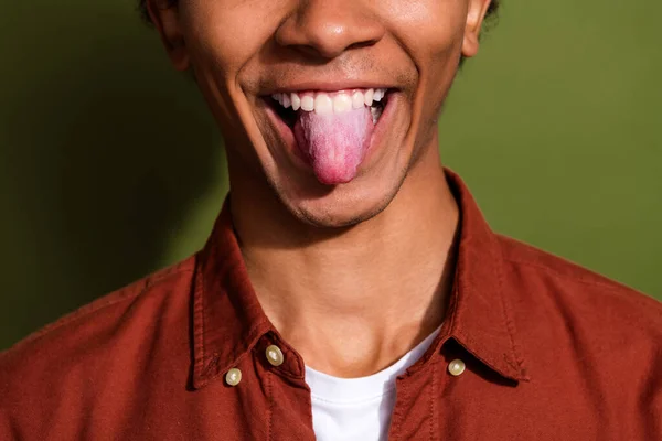 Close up photo of nice young man stick tongue out funny dressed stylish brown garment isolated on khaki color background.
