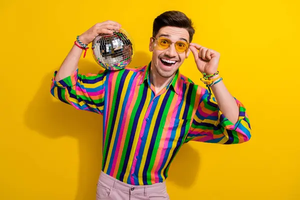 Photo of man amazing reaction when see you at party wear trendy vintage garment put disco ball shoulder isolated on yellow color background.
