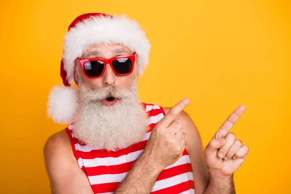 クールな印象を与えられた上級男クリスマス水着の写真は 2つの指の空のスペースを示すメガネを黄色の背景を隔離しました — ストック写真