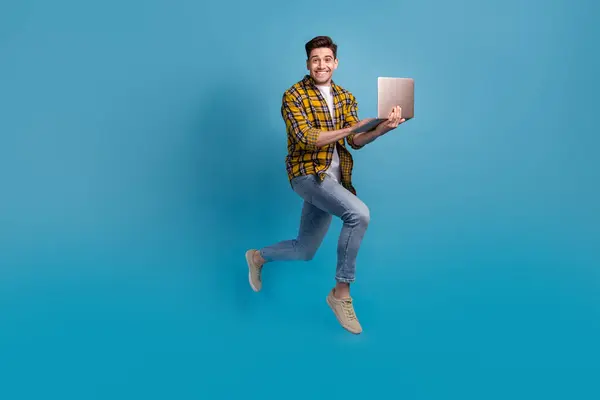Full length photo of man just learned new code language future programmer running to employers with laptop isolated on blue color background.