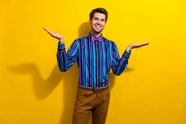 雅致男人穿着时髦衬衫的肖像领结手相比较产品空旷的空间隔离在鲜活的黄色背景 — 图库照片