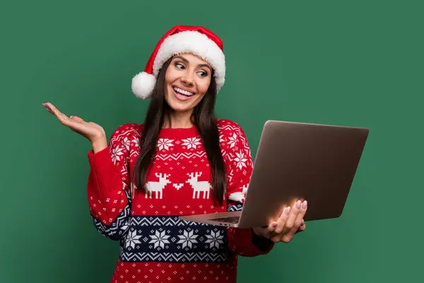 Photo of positive excited lady santa helper dressed print xmas sweater talking modern gadget isolated green color background.