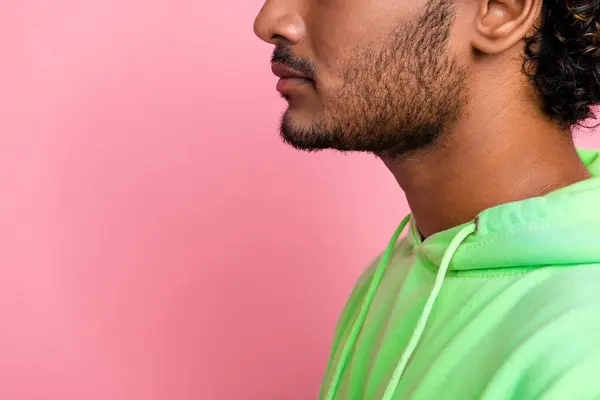 Side profile cropped photo unshaven unrecognizable indian serious man looking copy space skincare promo isolated on pink color background.