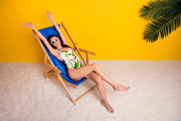 全长图片性感可爱的女士穿着泳衣休闲躺椅晒黑空旷的空间孤立的黄色背景 — 图库照片