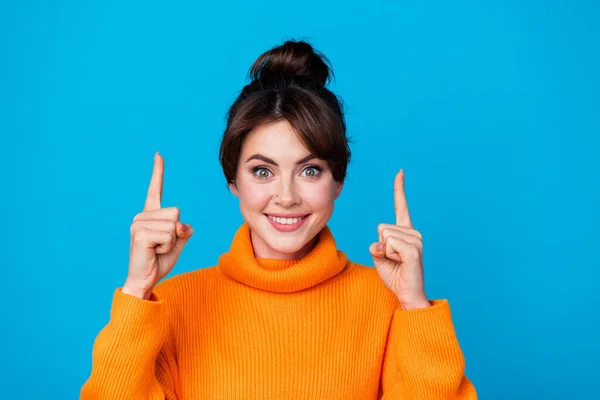 Photo of adorable excited lady wear knitted pullover showing two fingers up empty space isolated blue color background.