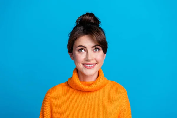 Photo of cheerful excited lady wear knitted pullover looking up empty space isolated blue color background.