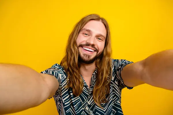Photo of positive good mood man dressed print shirt smiling recording video vlog isolated yellow color background.