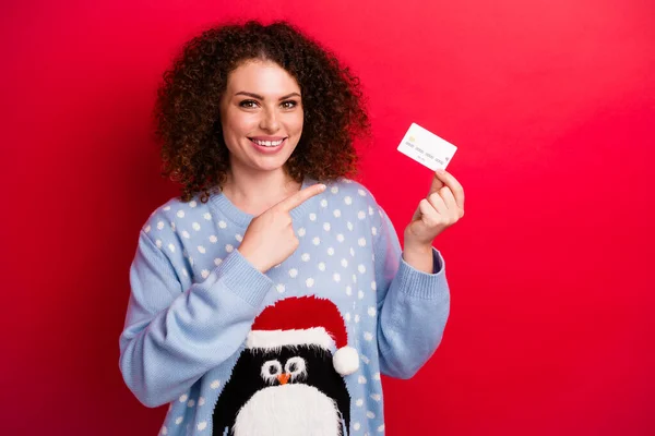 Portrait of lady wear xmas penguin pullover direct forefinger debit card for rich people vip clients ad isolated on red color background.