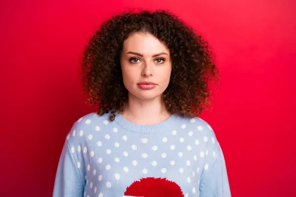 Portrait of funky lady with curly hair wear blue ugly sweater prepared for new year celebration isolated on bright red color background.