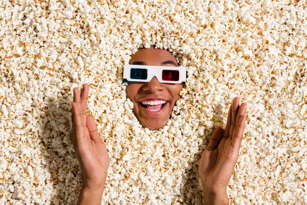 Photo of shocked surprised guy impressed with new movies tell friends fun video isolated full pop corn background.