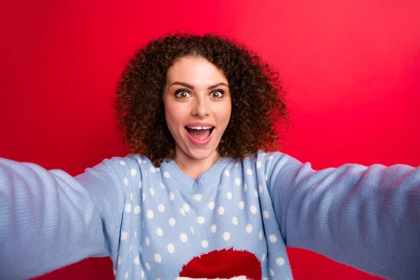 Photo of excited funky lady wear ugly new year pullover open mouth tacking selfie isolated red color background.