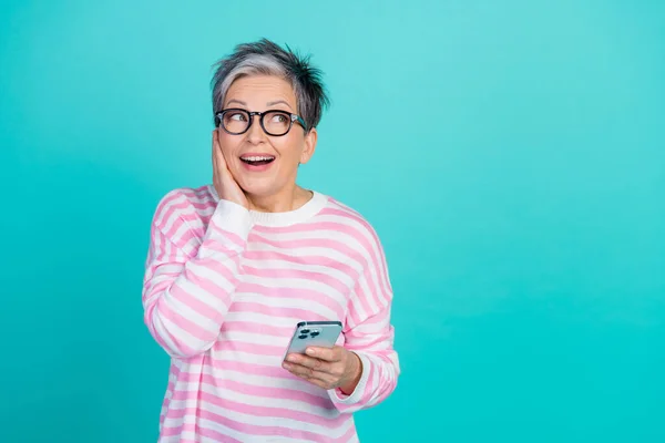 stock image Photo of funky excited woman dressed pink pullover chatting modern gadget looking empty space isolated teal color background.