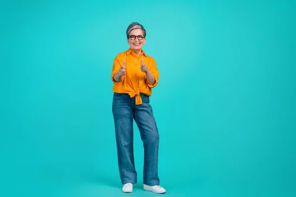 Full body photo of cheerful grandmother old woman gray haired model back to business point fingers you isolated on blue color background.
