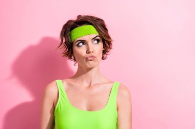 Photo of doubtful unsure woman dressed neon bodysuit looking empty space isolated pink color background. clipart
