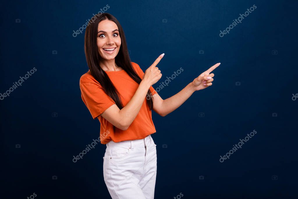 Portrait of ecstatic person with long hair wear stylish clothes directing at impressive offer empty space isolated on dark blue background.