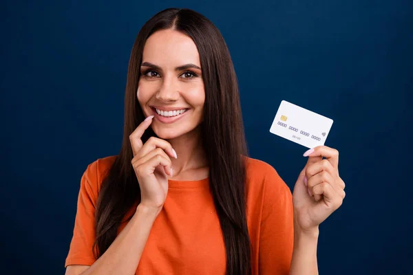 Portrait of smart person with long hairstyle wear stylish clothes show credit card finger on lips isolated on dark blue background.