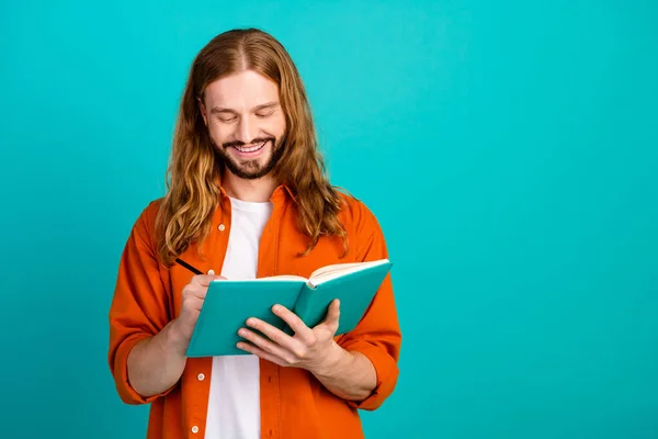Photo of smart handsome guy with wavy hairdo wear stylish outfit write to do list in notebook isolated on turquoise color background.