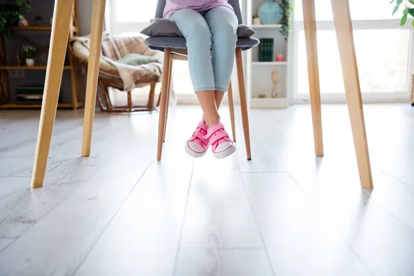 Cropped Photo Little Girl Legs Jeans Sneakers Sitting Chair Desktop — Stock Photo, Image