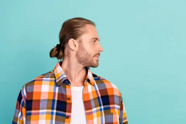 Portrait of brutal cool man with stubble wear flannel plaid jacket look at offer empty space isolated on turquoise color background.