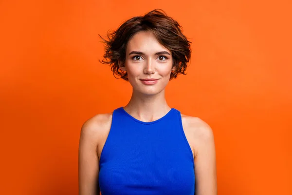 Portrait of young nice model bob brown hair girlfriend wearing blue singlet for elegant party isolated on bright orange color background.