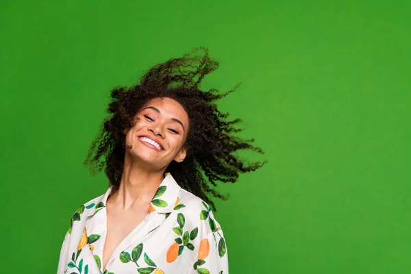 Photo of carefree sweet woman dressed print shirt having fun dancing empty space isolated green color background.