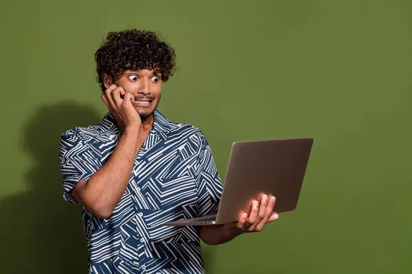 Photo of funky nervous man dressed print shirt reading news modern gadget empty space isolated green color background.