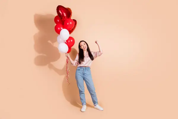 Full size photo of optimistic ecstatic woman dressed silk blouse hold bubbles celebrate valentine day isolated on beige color background.