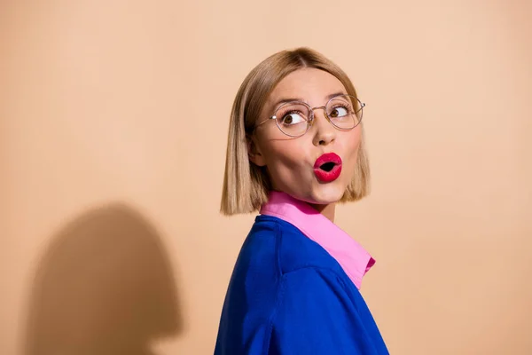 Portrait photo of blonde bob hair lady in blue jumper shocked pouted lips red pomade look novelty isolated on beige color background.