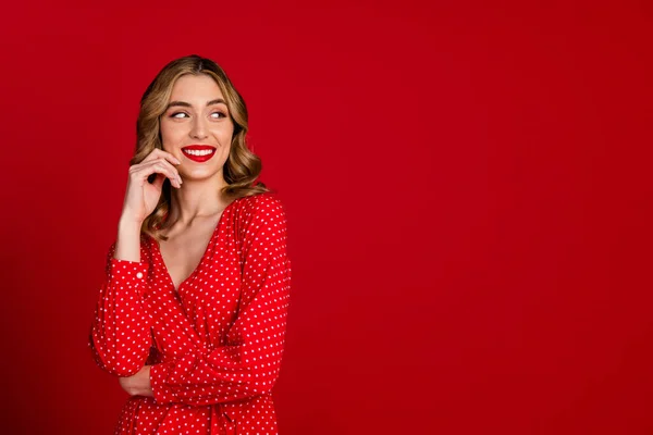 Photo of gorgeous positive minded girl beaming smile look empty space ad isolated on red color background.