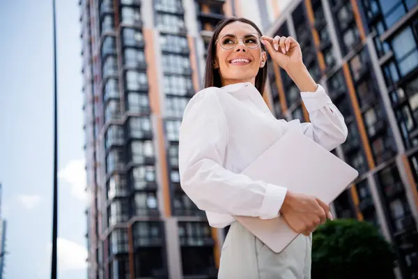 Photo of gorgeous stunning lady professional boss dressed stylish shirt hand hold eyeglasses look modern business center office buildings.